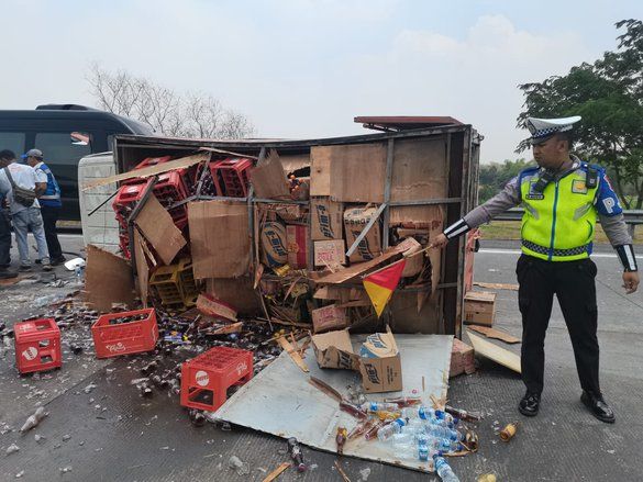 Pecah Ban, Truk Boks Bermuatan Teh Botol Terguling di Tol Sumo 